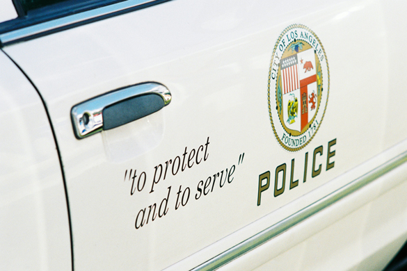 "to protect and to serve" slogan on police car door.
