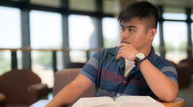 Student studying in COC library. 