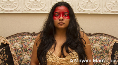 Young woman painted with red stripe across face