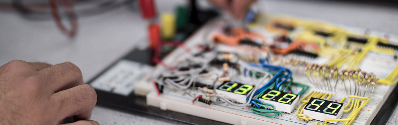 Student learning Electronic Systems board. 