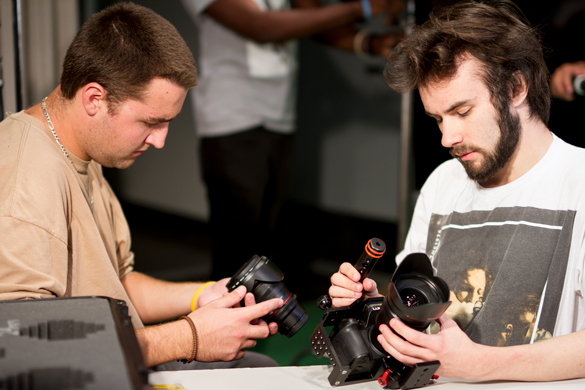 Film students looking at camera equipment. 