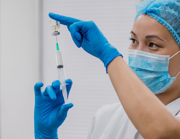 Pharmacist prepares a syringe.