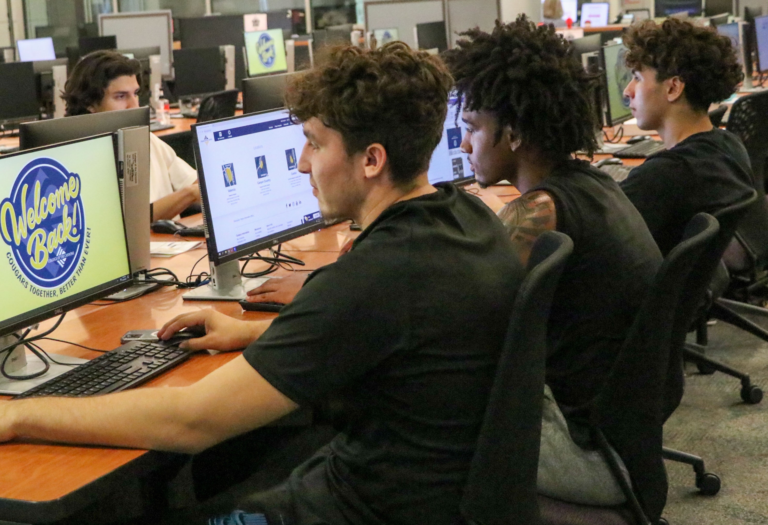 Student Athletes working on computer in TLC