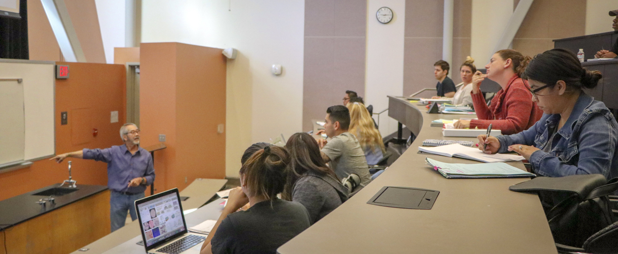 Students listen to a biology lecture.