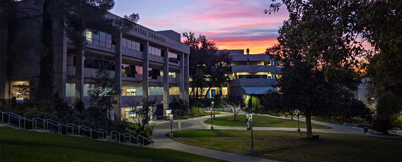 The sun sets behind Bonelli Hall and Boykin Hall at the Valencia campus.)
