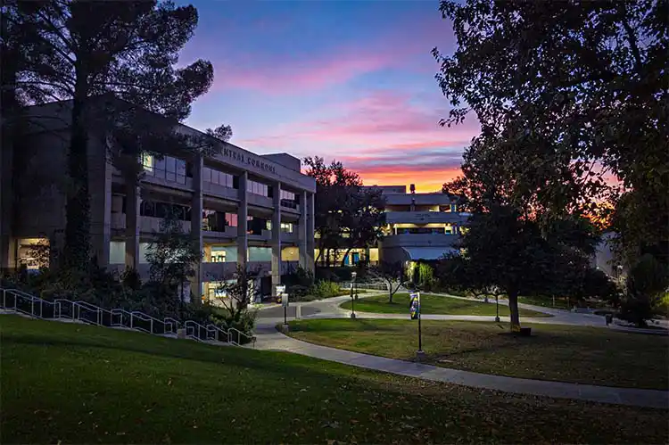 The sun sets behind Bonelli Hall and Boykin Hall at the Valencia campus.