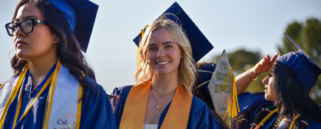 Students in caps and gowns participate in commencement.