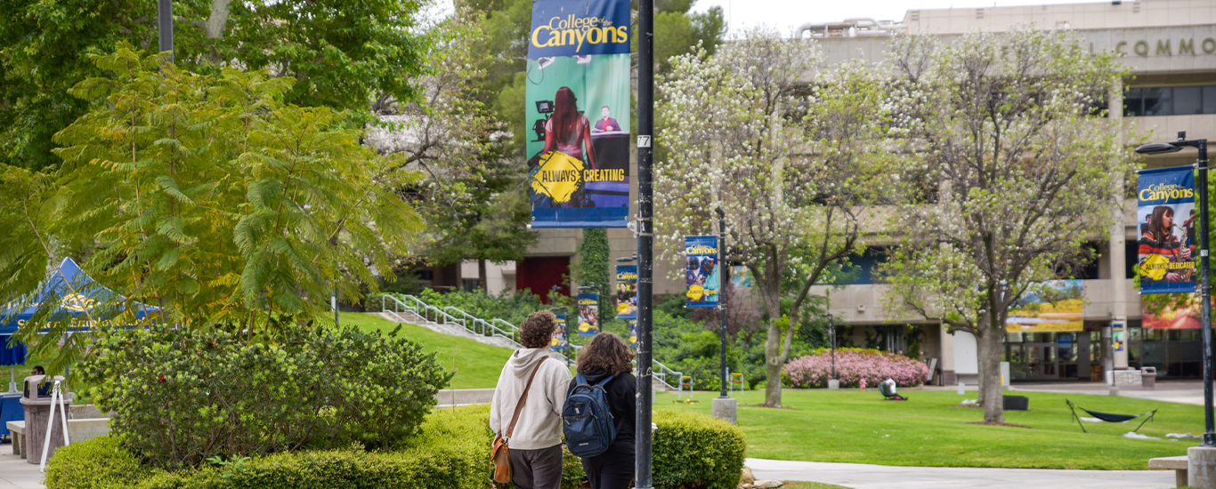 Students walk in the Honor Grove at the Valencia campus.