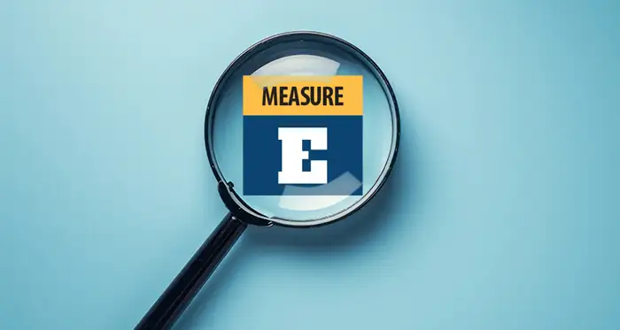 Illustration of magnifying glass bringing "Measure E" into focus.