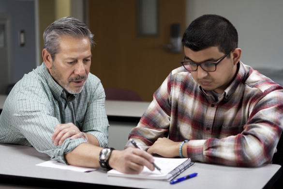 Architecture instructor working with student on project. 