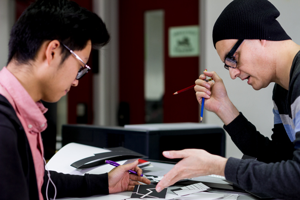 Architecture instructor working with student on project. 