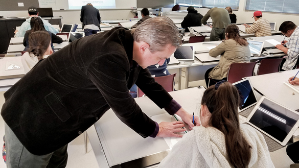 Architecture instructor working with student on project. 