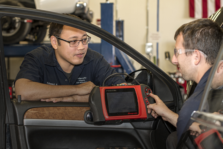 Two Automotive students using MODIS Snap-on engine tester. 