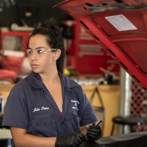 Auto mechanic student under the hood of the car. 