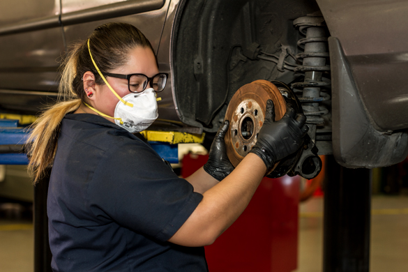 Auto mechanic student working on brakes. 