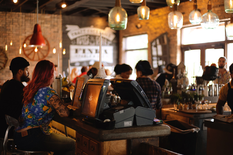 Restaurant, bar filled with customers.