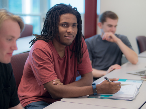 Buisness students listening in class to instructor. 