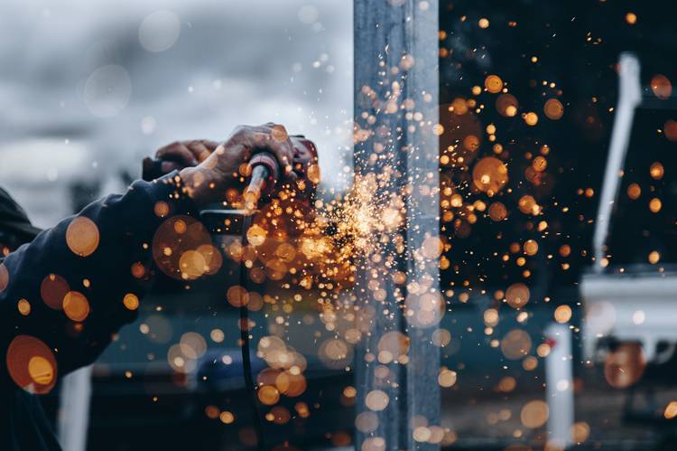 Construction worker using a grinder.