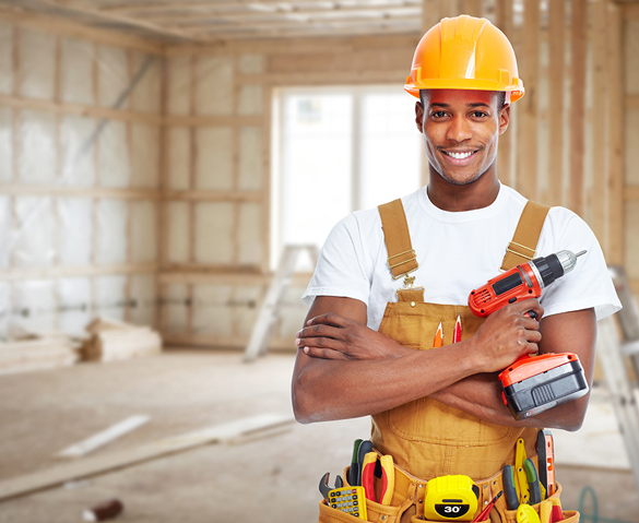 Carpenter with drill and hard hat.