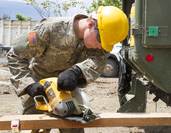 Military carpenter with electric saw.
