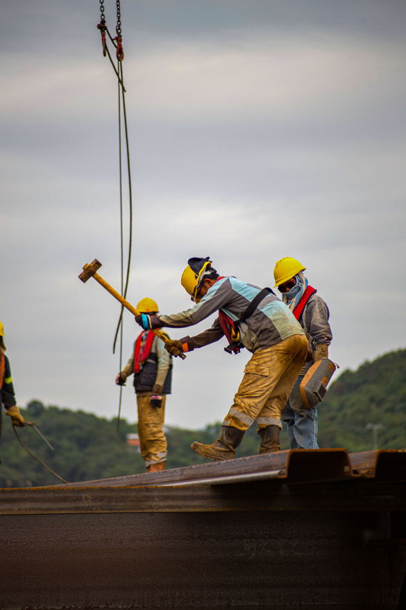 Construction workers on steel beams.