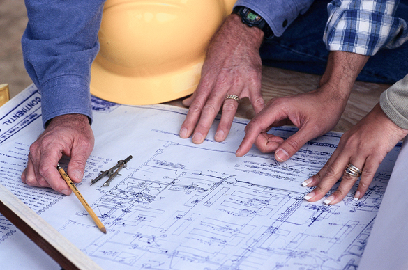 Construction workers looking at blueprint.