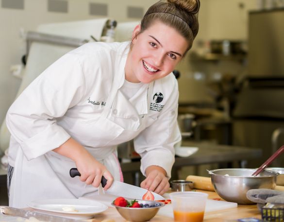 Student chef preparing dessert.  