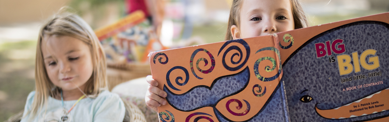 Two young students reading books. 