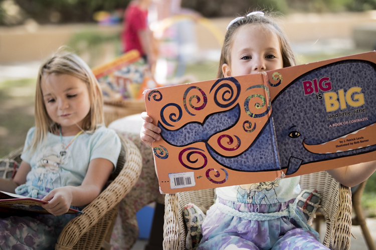 Two young students reading books. 