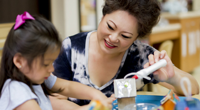 Early Childhood Education student doing project with teacher. 