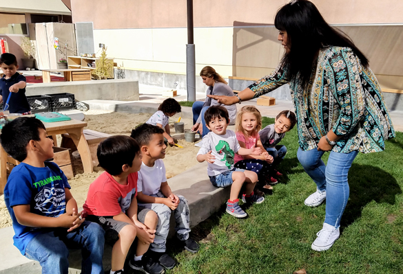 Children with teacher learning through playtime at Center for Early Childhood Education. 