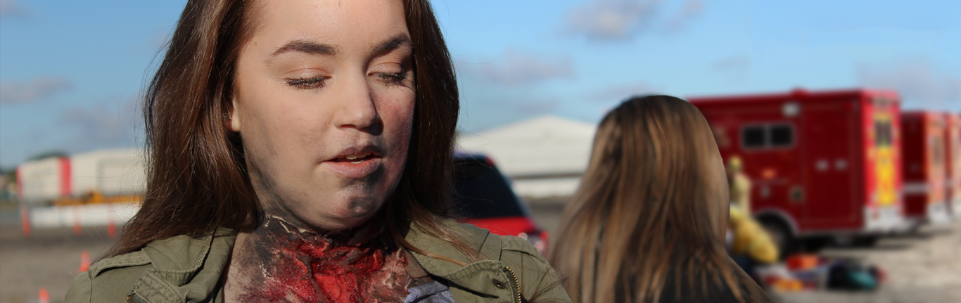 COC EMT student with neck wound moulage.