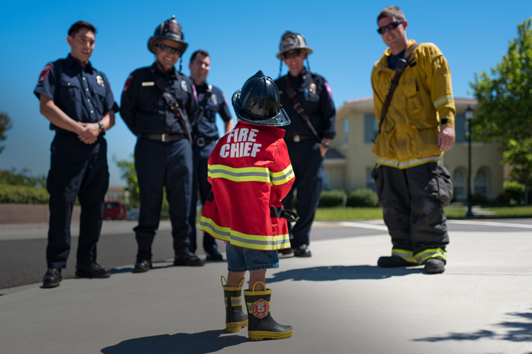 Fire Fighters smiling and talking to young future "Fire Chief".
