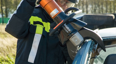 Firefighter using the jaws of life on a car.