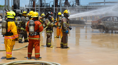 Firefighters extinguishing a car fire.