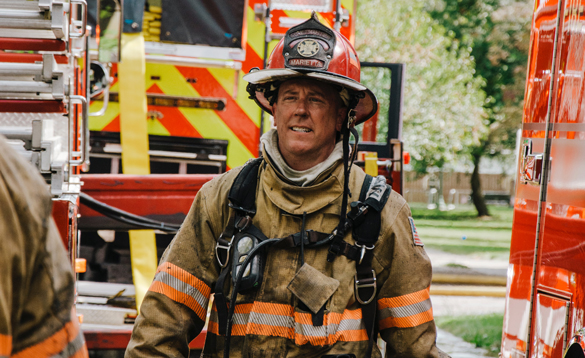 Fire fighter in full helmet and gear.