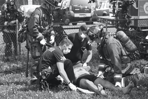 Firefighters tending to injured person.