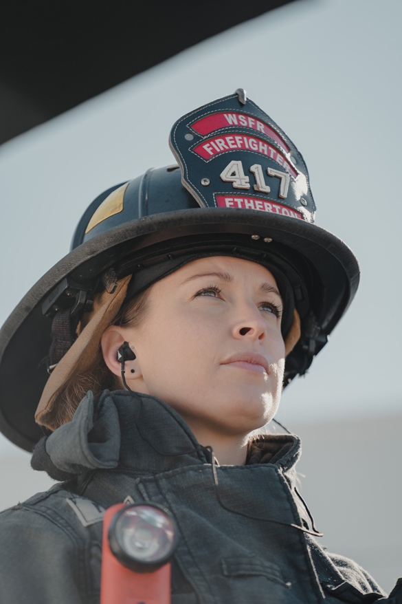 Female fire fighter in full gear.