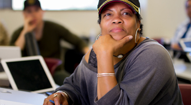 Female Inerior Design student taking notes in class. 