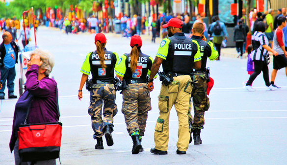 Police officers patroling in a crowd.