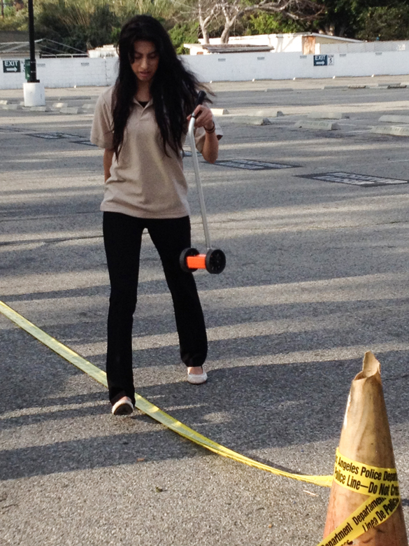 Student Taking Measurements of Mock Crime Scene