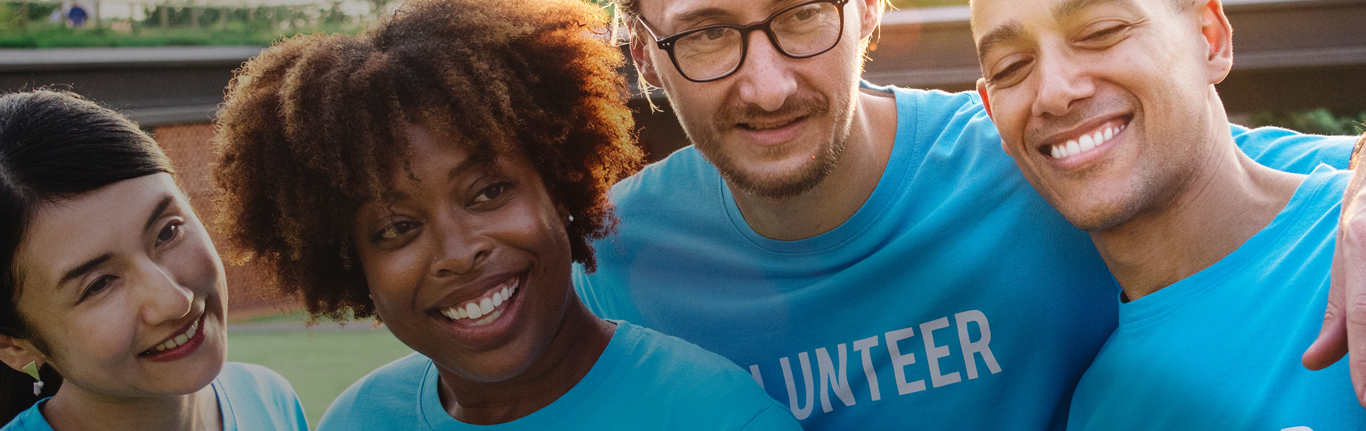 Four people in blue volunteer T-shirts.