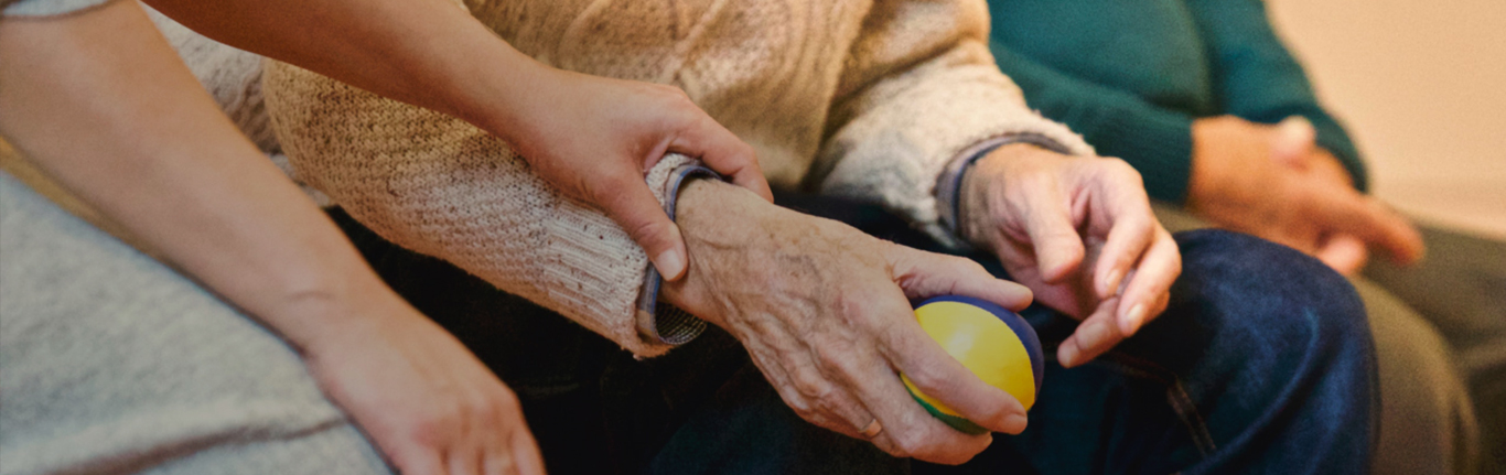 Comforting hand on elderly person.