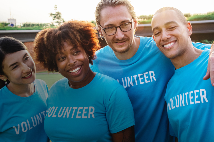 Four people in blue volunteer T-shirts.