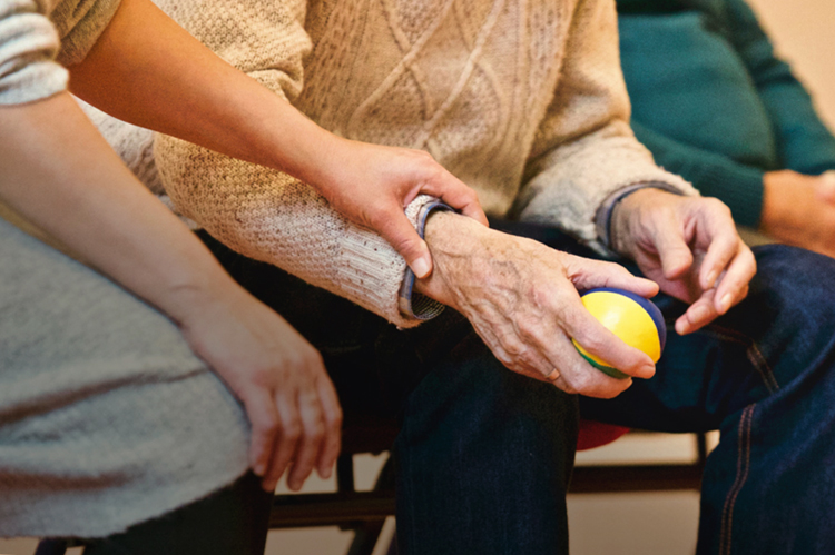 Comforting hand on elderly person.