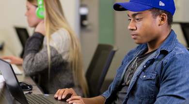 Media Entertainment Arts students on computers.
