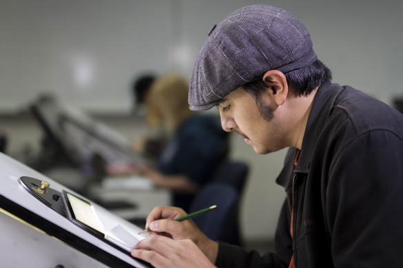 Media Entertainment Arts students on computers.  