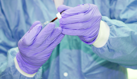 Medical Laboratory Technician student checking a blood sample.  