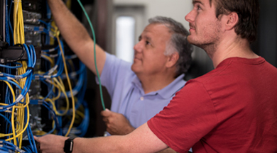 Faculty and student in networking wires.  