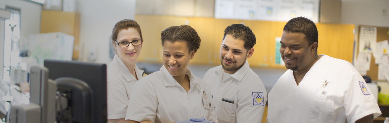 Four nurses looking at computer data.